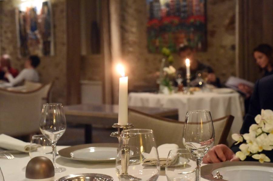 Candlelit dinner table set for a family
