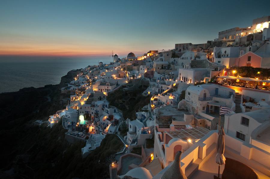 Whitewashed village above the Aegean at dusk